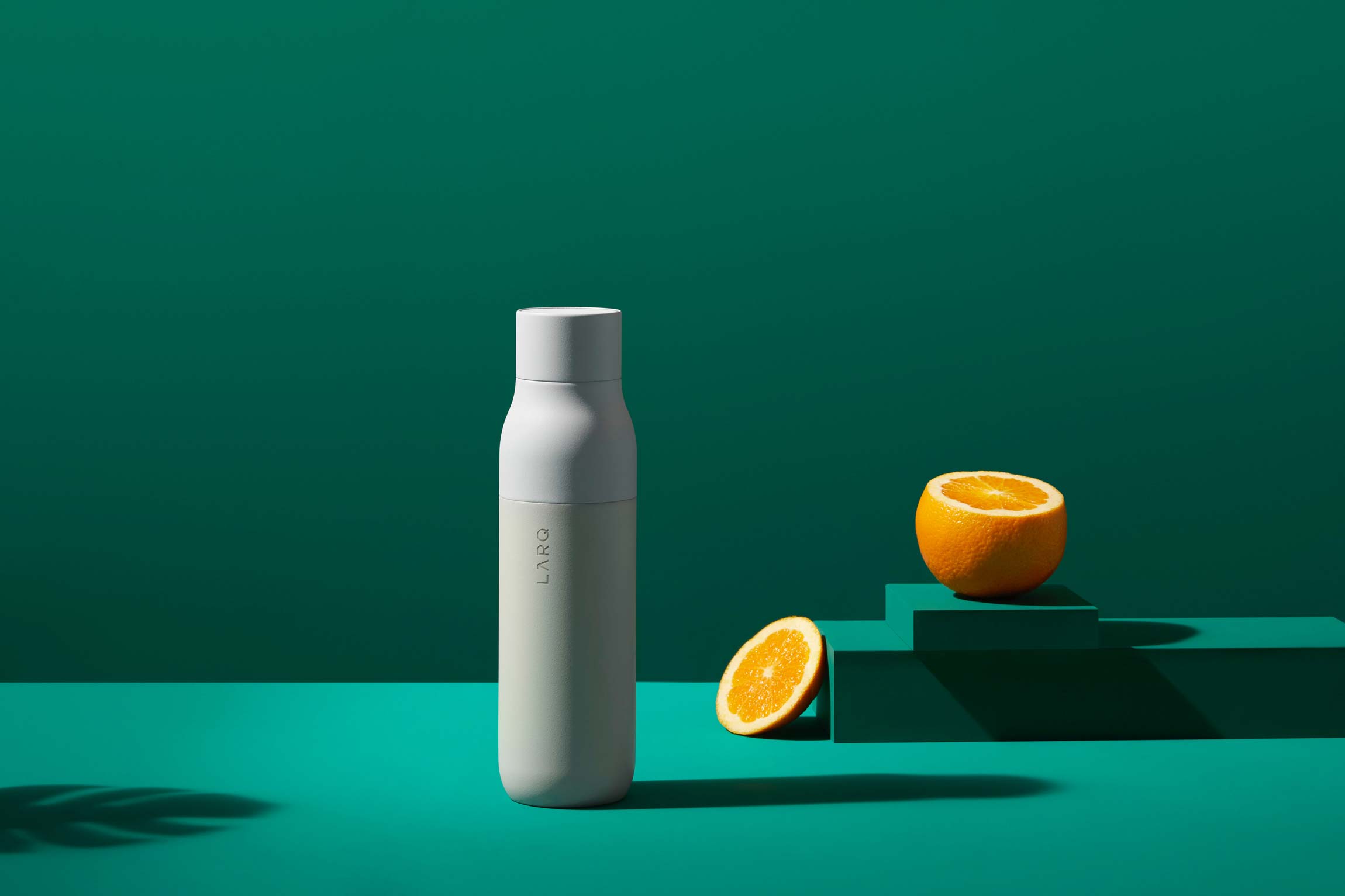 A Bottle Placed on a Green Color Background